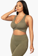 Load image into Gallery viewer, Olive Green &quot;V&quot; shaped sports bra. DH logo on left side.
