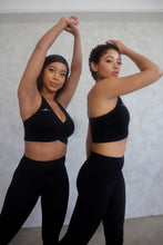 Load image into Gallery viewer, Black &quot;V&quot; shape sports bra. DH logo on right side.
